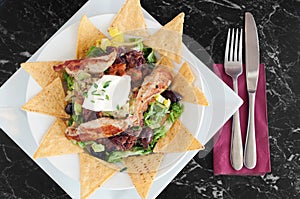 Mexican nachos with grilled chicken fillets