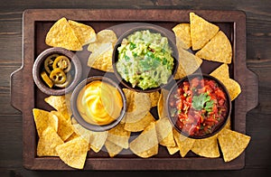 Mexican nachos tortilla chips with guacamole, salsa and cheese d