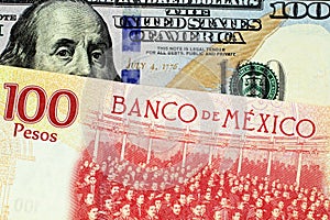 A Mexican one hundred peso bill with an American one hundred dollar bank note