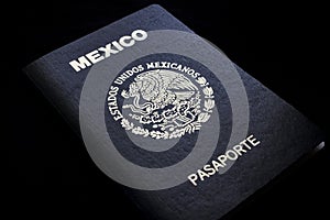 Mexican passport in a black background photo