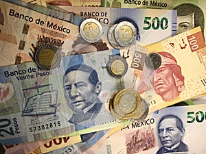 Mexican peso bills spread randomly over a flat surface