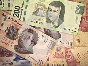 Mexican peso bills spread randomly over a flat surface