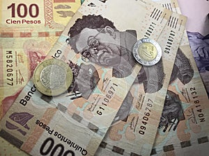 Mexican peso bills spread randomly over a flat surface