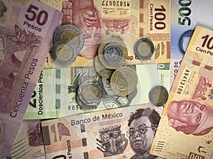 Mexican peso bills spread randomly over a flat surface