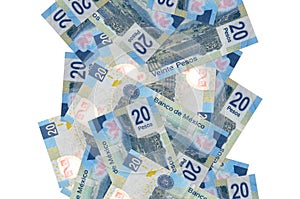 20 Mexican pesos bills flying down isolated on white. Many banknotes falling with white copyspace on left and right side photo