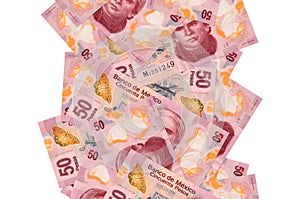 50 Mexican pesos bills flying down isolated on white. Many banknotes falling with white copyspace on left and right side photo