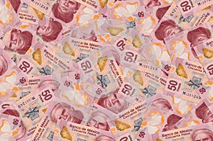 50 Mexican pesos bills lies in big pile. Rich life conceptual background photo