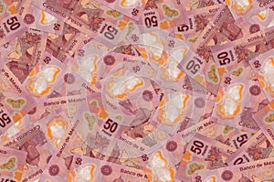 50 mexican pesos bills lies in big pile. Rich life conceptual background photo