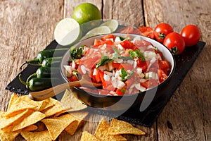 Mexican Pico de Gallo with ingredients closeup and nachos. horizontal