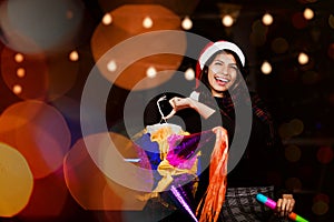 Mexican Posada, Latin Woman Holding a colorful PiÃ±ata and celebrating a traditional Posada in Christmas Mexico