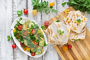 Mexican Quesadilla wrap with chicken, corn and sweet pepper and fresh salad.