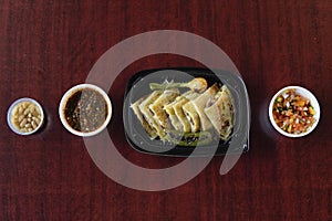 Mexican quesadillas with green chili pepper and onion  with salsas and white beans photo