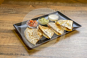 Mexican quesadillas stuffed with chili con carne and with pico de gallo photo