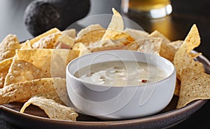 Mexican queso blanco cheese dip with corn tortilla chips photo