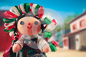 Mexican rag doll in a traditional dress on a mexican village