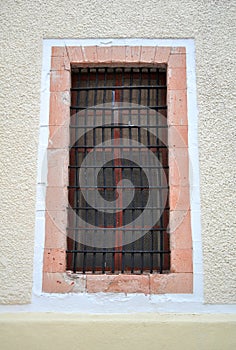 Mexican Rustic Colonial window with bars and metal mesh photo