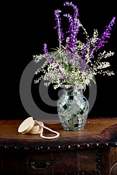 Mexican sage with silver lace flowers in a mosaic vase next to a