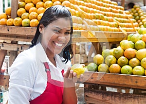 Mexican saleswoman offering fruits on a farmers market