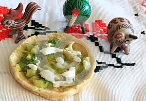 Mexican Salsa Verde Gordita and clay animal figurines