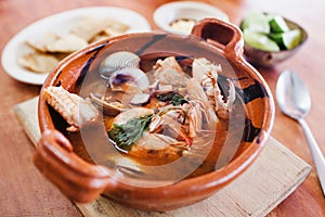 Mexican seafood soup, cazuela de mariscos in Mexico is a bowl of spicy food with shrimps and fish photo