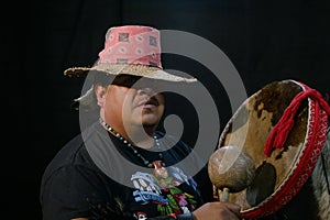 mexican shaman doing authentic ritual of summoning spirits. shaman with jewelry holding drum with incense. Shamanic ritual in