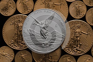 Mexican Silver Libertad Coin over tones of American Gold Eagles