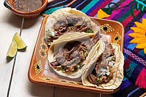 Mexican slow cooked lamb tacos also called barbacoa on white background photo