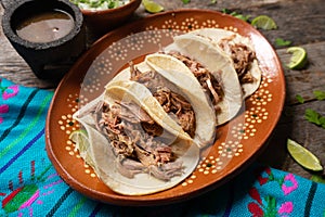 Mexican slow cooked lamb tacos also called barbacoa on wooden background photo