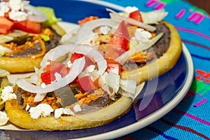 Mexican sopes made with chicken tinga