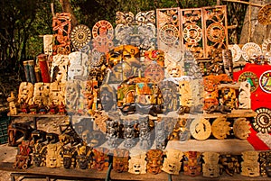 Mexican Souvenirs made of wood in the market for tourists. Masks tribe Maya, skulls, figurines and arts and crafts. Mexico