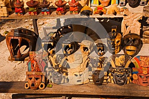 Mexican Souvenirs made of wood in the market for tourists. Masks tribe Maya, skulls, figurines and arts and crafts. Mexico