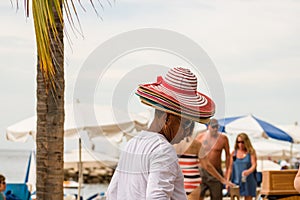 Mexican street vendor selling straw handbags and hats on the waterfront, Malecon, in Puerto Vallarta, Mexico, 2020