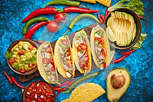 Mexican taco with chicken meat, jalapeno, fresh vegetables served with guacamole