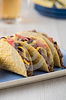 Mexican tacos with beef, cheddar cheese, tomato