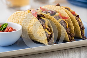 Mexican tacos with beef, cheddar cheese, tomato