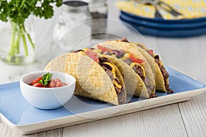 Mexican tacos with beef, cheddar cheese, tomato