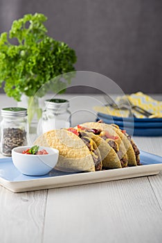 Mexican tacos with beef, cheddar cheese, tomato