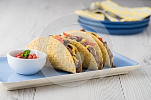 Mexican tacos with beef, cheddar cheese, tomato