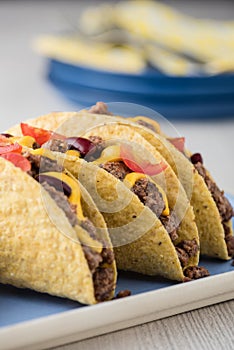 Mexican tacos with beef, cheddar cheese, tomato