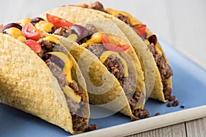 Mexican tacos with beef, cheddar cheese, tomato