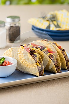 Mexican tacos with beef, cheddar cheese, tomato