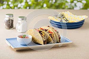 Mexican tacos with beef, cheddar cheese, tomato