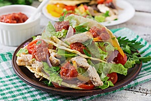 Mexican tacos with chicken, black beans and fresh vegetables