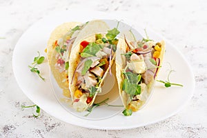 Mexican tacos with chicken meat, corn and salsa. Healthy tacos.