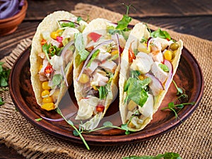 Mexican tacos with chicken meat, corn and salsa. Healthy tacos. Diet menu.