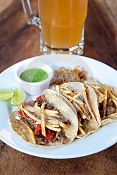 Mexican tacos with corn tortillas. Traditional Mexican food. Mexican food on wooden background. Mexican traditional food concept