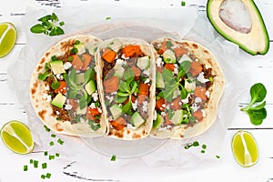 Mexican tacos with meat, sweet potatoes and cotija cheese.