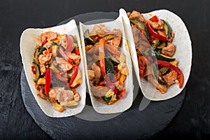 Mexican tacos with pork and vegetables. Al pastor taco on slate tableware.