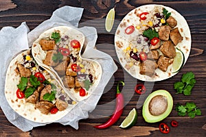 Mexican tacos with quinoa salad, meat, black beans and corn on rustic wooden table. Recipe for Cinco de Mayo party. photo