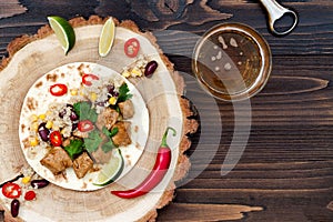 Mexican tacos with quinoa salad, meat, black beans and corn on rustic wooden table. Recipe for Cinco de Mayo party. photo